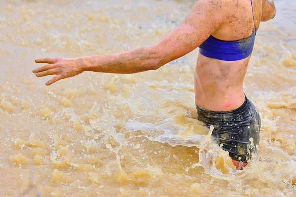 Woman walking in dirty water — Stock Photo, Image