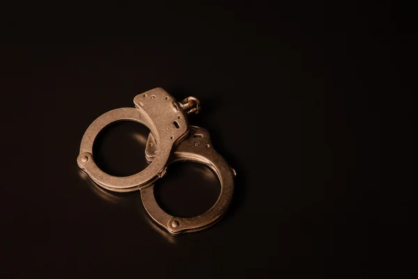 Handcuffs on Black Background — Stock Photo, Image