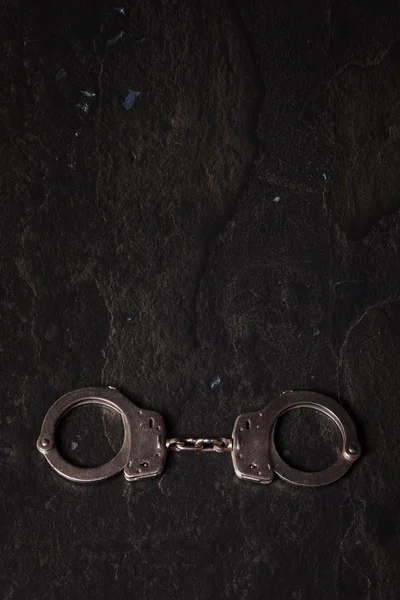 Handcuffs on Black Background Stock Photo by ©luvemak 99668450