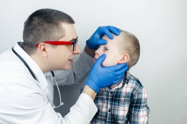 An ophthalmologist examines a boy who complains of burning and pain in his eyes. Eye fatigue from a computer or phone screen (sensation of sand on the cornea). Diagnosis of conjunctivitis in children. clipart