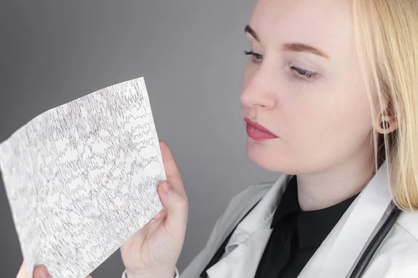 A neurologist examines an encephalogram of a patients brain. Schedule of electroencephalograms study of brain currents for signs of epilepsy and pathologies of the nervous system