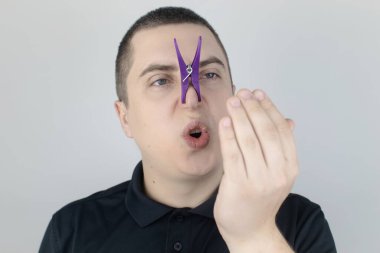 Nefesi kokan bir adam kameraya bakar. Kötü kokulu konsept. Ağzından pis bir koku duyan birinin yakın çekimi. Mide sorunları, ağız temizliği, tütün kokusu, diyet yan etkileri.