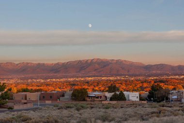 City of Albuquerque and the Sandia Mountains, New Mexico in fall sunset clipart