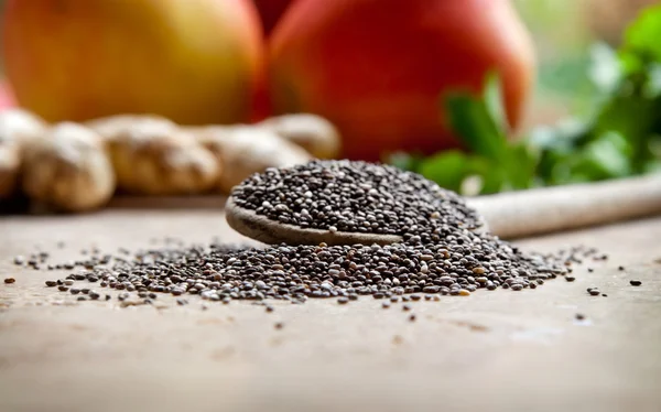 Sementes de Chia com frutas e legumes no fundo — Fotografia de Stock