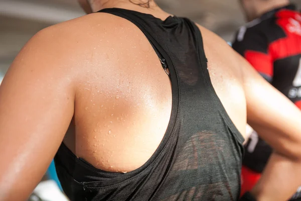 Detail gym shot,sweat skin of a woman's back, spinning, aerobic class
