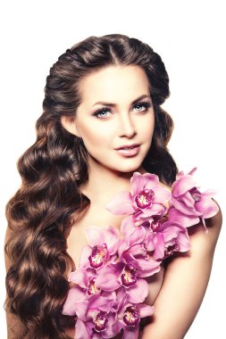 Beauty young woman, luxury long curly hair with orchid flower. H