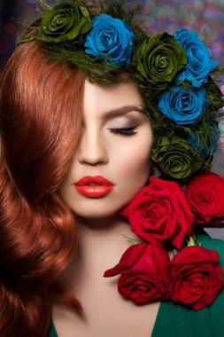 Beautiful model woman with blue, green and redrose flower in hai clipart