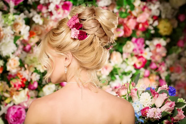 Penteado de casamento uma jovem. Noiva. Mulher com flores em seu — Fotografia de Stock