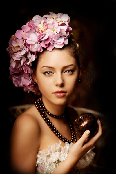 Retro woman. Girl in vintage style with flowers in the hairstyle