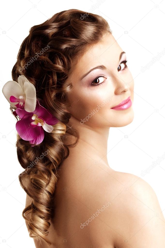 Makeup and hairstyle. Young beautiful woman with luxurious hair.