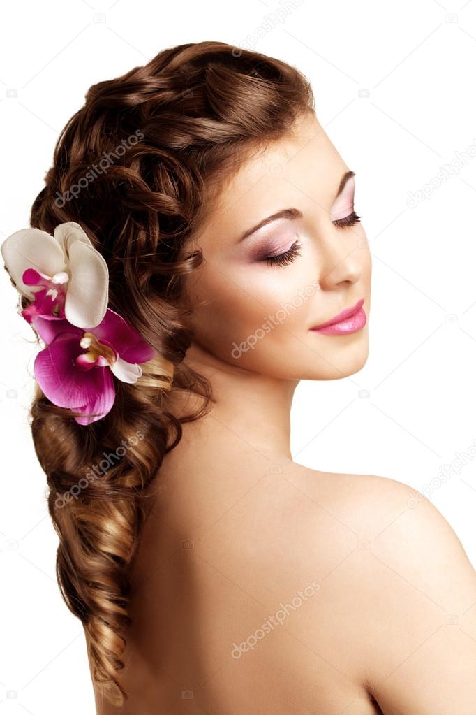 Makeup, hairstyle. Young beautiful woman with luxurious hair. Mo