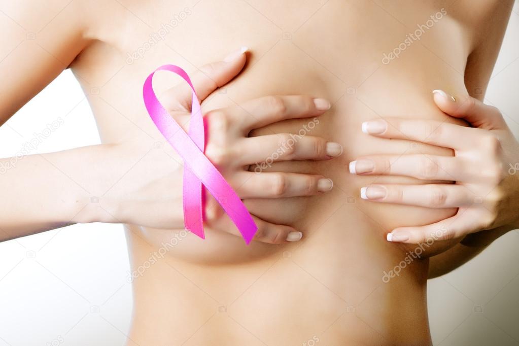 Breast cancer. Pink ribbon on a woman's breasts. Concept of medi