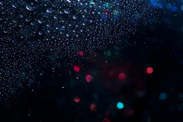 Abstracte achtergrond textuur druppels water en kunst licht op glas — Stockfoto
