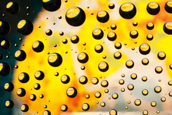 Abstracte achtergrond textuur druppels water en kunst licht op glas — Stockfoto