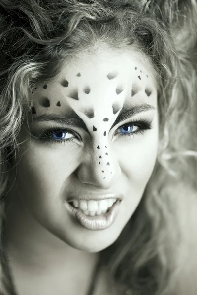 Beauty woman with makeup in snow leopard style. Fashion makeup m Stock Photo