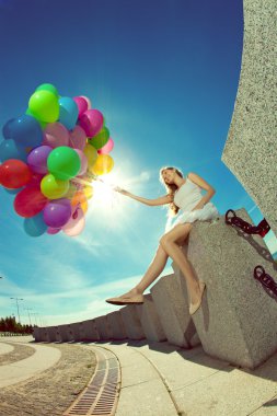 Happy young woman having fun in springtime in city. Girl jumping