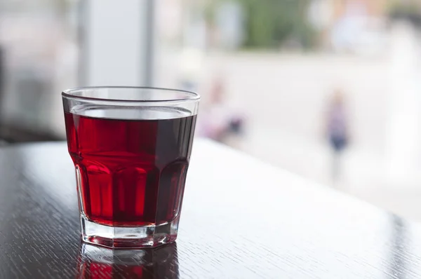 Glass of compote on wooden table — Stock Photo, Image