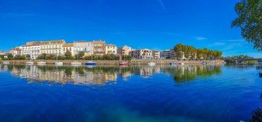 Panorama view of Herault river at the town Agde with buildings, Languedoc-Roussillon France clipart