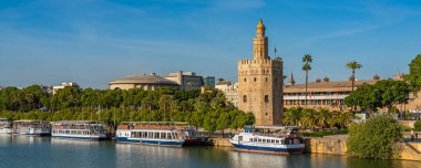 SEVILLE-SPAIN, OCTOBER 18. 2020 : Torre del Oro, Seville, Spain. Military watchtower erected in order to control access to Seville via the Guadalquivir river, panorama