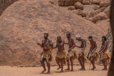 DAMARALAND, NAMIBIA - 13 Ocak 2020: Damara halkı geleneksel giysiler içinde Twyfelfontein, Namibya 'daki Damara Canlı Müzesi' nde geleneksel dans gösterisi yapıyorlar
