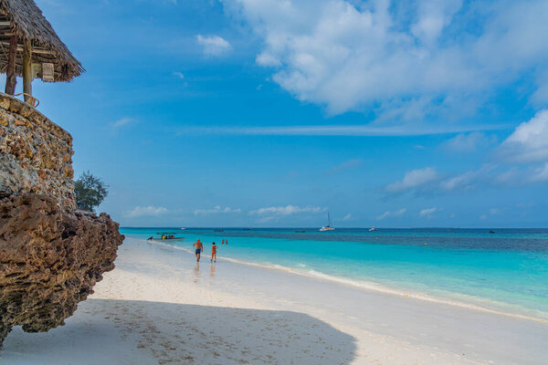 Nungwi Beach, Zanzibar-Tanzania, February 12, 2020 : People at the tropical white beach of Zanzibar island. Tanzania. Eastern Africa, copy space for text