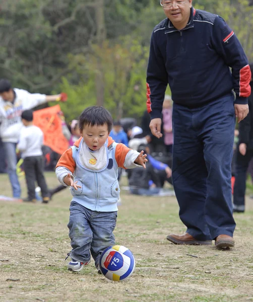 Baby playing football with his father — Stock Photo, Image