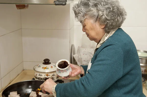 cooking grandmother in kitchen