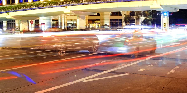 High speed and blurred cars light trails in downtown nightscape — Stock Photo, Image