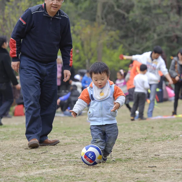Baby playing football with his father — Stock Photo, Image