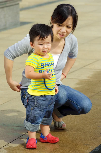 Happy baby is playing with his mothe — Stock Photo, Image