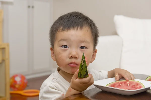 A baby eating armelon — стоковое фото