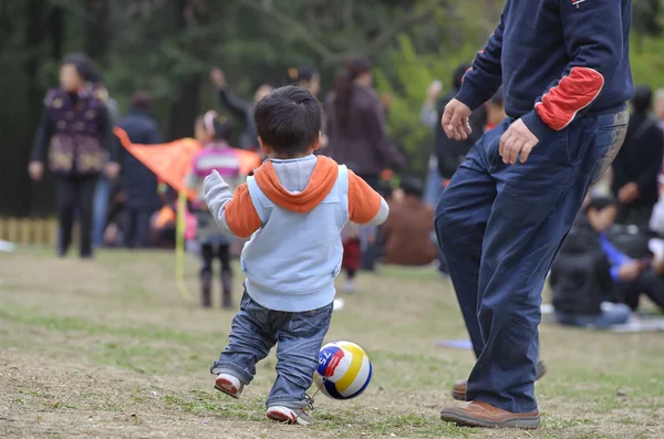 Baby playing football with his father — Stock Photo, Image