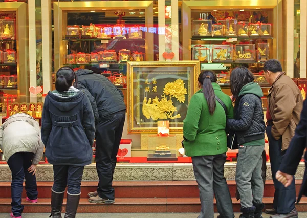 People stop to look in the window of a gold shop — Stock Photo, Image