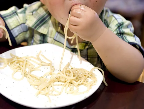 Eating baby to grab pasta — Stock Photo, Image