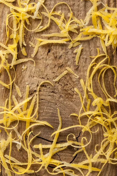 Lemon zest on wooden board — Stock Photo, Image