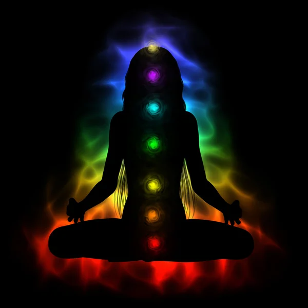 Silueta de mujer de pelo largo meditando - chakras de colores Fotos de stock libres de derechos