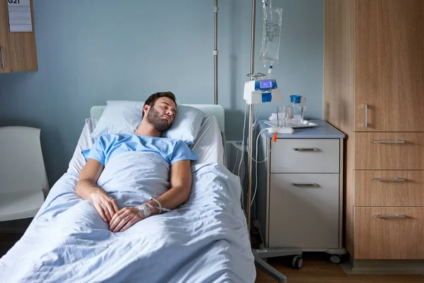 Sick Young Man Lying Asleep Bed Hospital Room Attached Intravenous — Stock Photo, Image