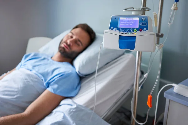 Closeup Infusion Pump Standing Sick Young Man Asleep Hospital Bed — Stock Photo, Image