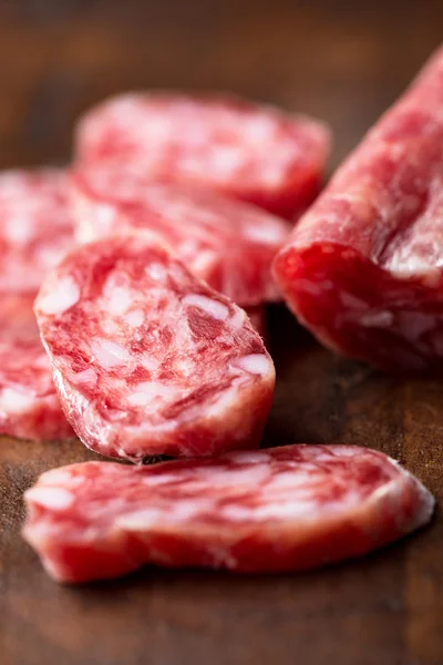 Salami op houten achtergrond — Stockfoto