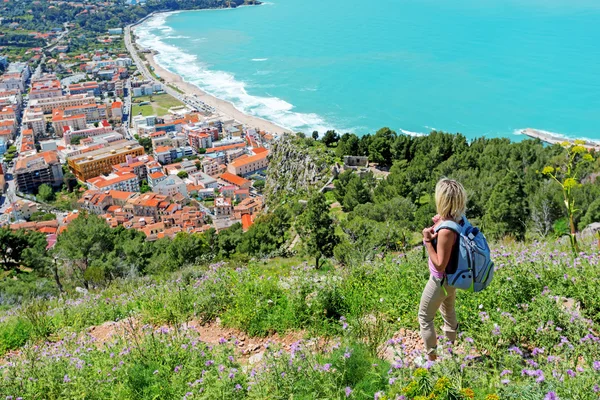 Blond woman looking on old red roofs — Stock Photo, Image