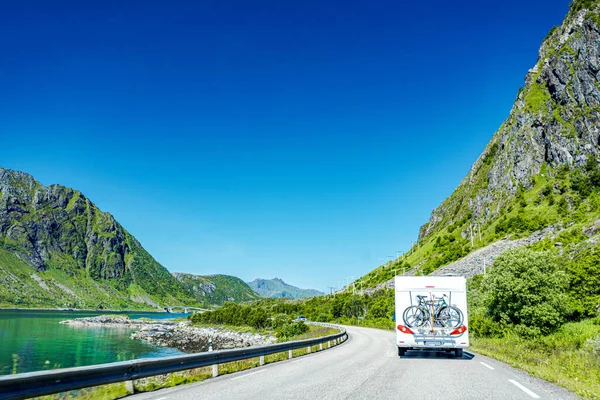 Camper trailer on road in Lofoten, Norway, road trip in motorhome