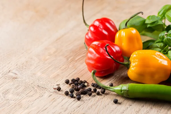 Peppers and tomato on table — Stock Photo, Image