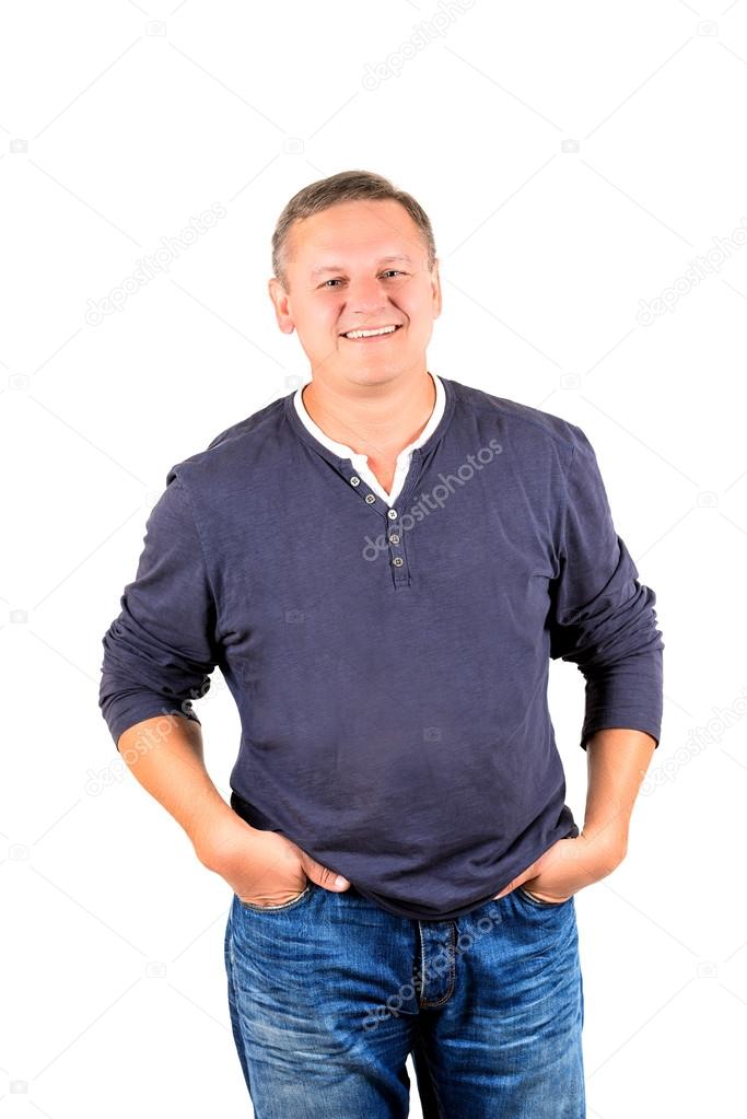 Casually dressed middle aged man in jeans and smiling