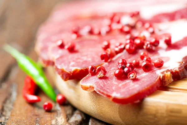 Cured meat with chilli pepper — Stock Photo, Image