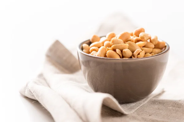 Peanuts in a bowl on tablecloth — Stock Photo, Image