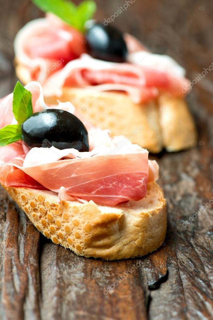 Sandwiches with prosciutto olives — Stock Photo © Nanisimova_sell 57855421