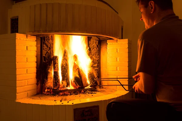 Man adjusting firewood