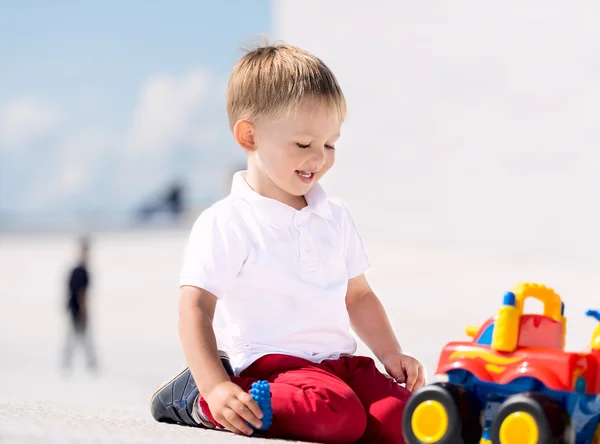 Little boy playing with toy car — Stock Photo, Image