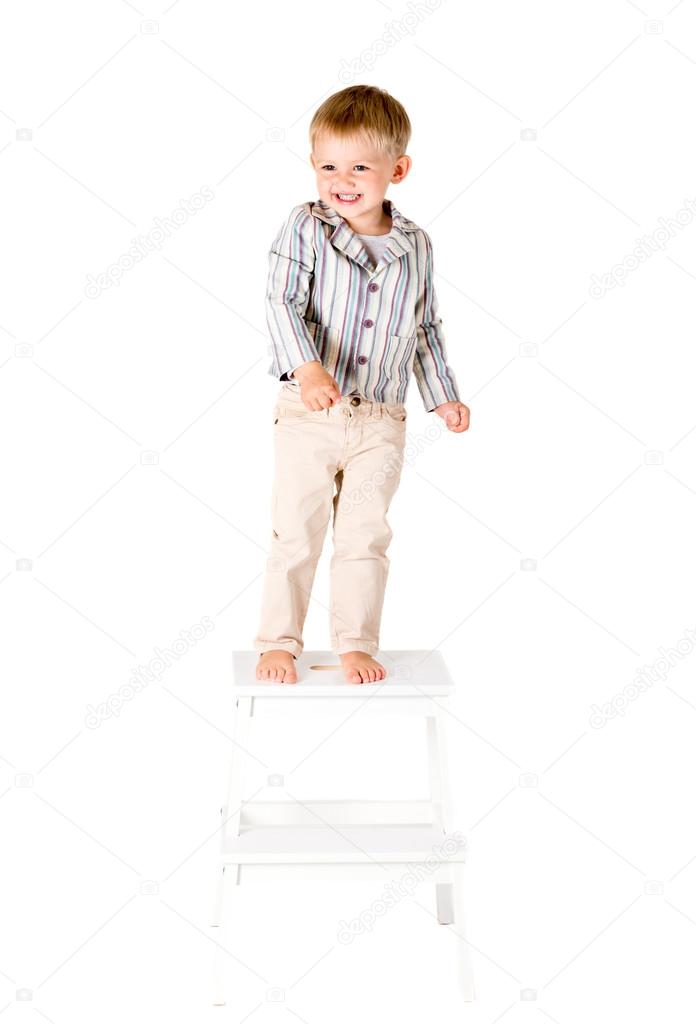 Boy standing on stool