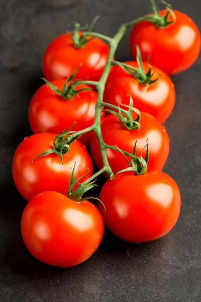 Tomatoes on dark table — Stock Photo, Image